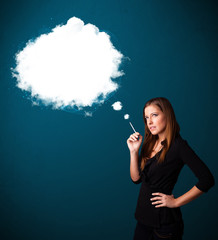 Fototapeta premium Young woman smoking unhealthy cigarette with dense smoke