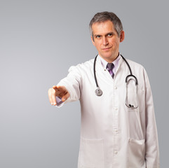 Middle aged doctor gesturing with copy space