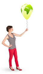 Happy lady holding a green globe balloon