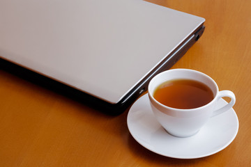 Fototapeta na wymiar Cup of tea and laptop