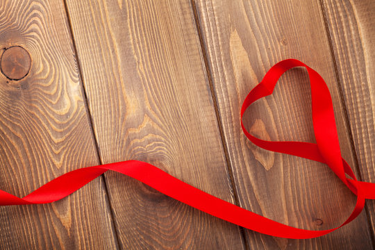 Heart shape ribbon over wood valentines day background