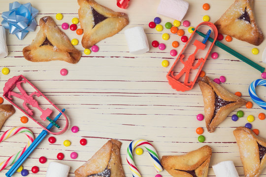 Hamantaschen cookies and candy background. View from above