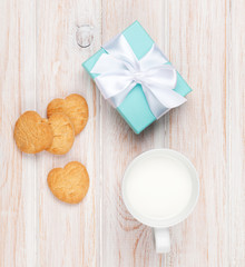 Cup of milk, heart shaped cookies and gift box