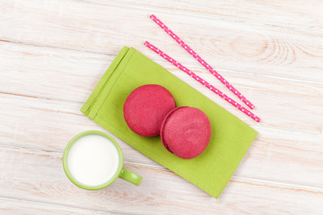 Colorful macarons and cup of milk