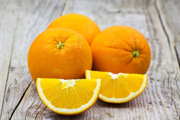 fresh oranges on old wooden background