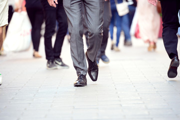 Business man in suit walking on sidewalk