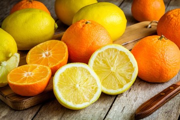 ripe mandarins and lemons on a cutting board