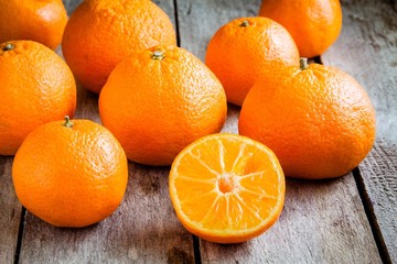 ripe mandarins cut on a wooden background