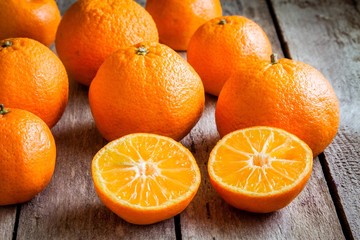 ripe mandarins cut on a wooden background