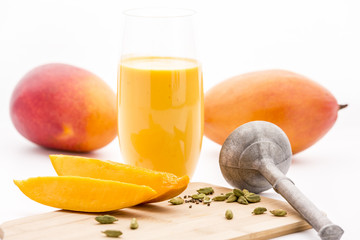 Crushed Cardamon, Pestle, Mangos And Mango Lassie