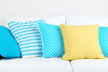 White sofa with colorful pillows in room