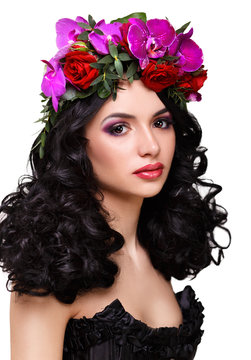 beautiful girl with a wreath of orchids on head. 