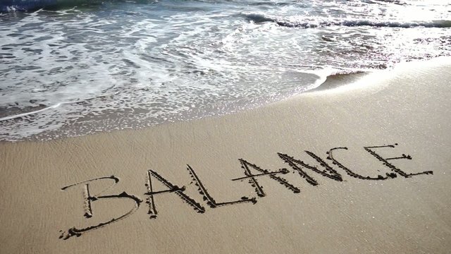 the word balance written on a sand beach