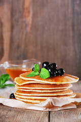 Stack of pancakes with mint and berries