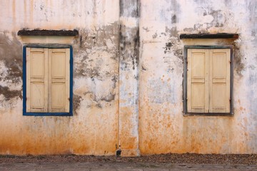 Two antique window frames on an old wall