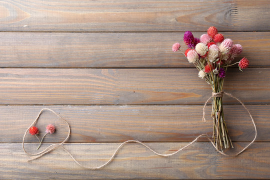 Bouquet Of Dried Flowers On Wooden Planks Background