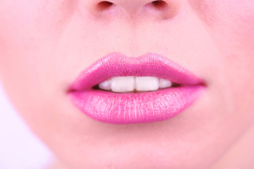Pink lipstick on lips, macro