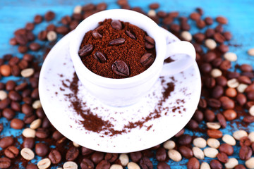 Coffee beans in white ceramic cup with saucer