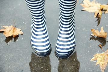 Woman in Boots on rainy autumn day.