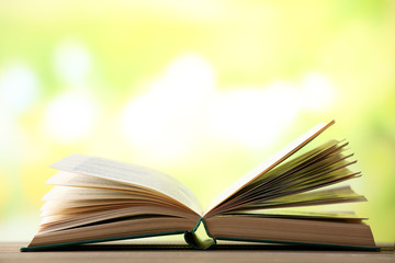 Open book on blurred bright background