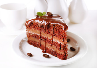 Delicious chocolate cake on plate on table on light background