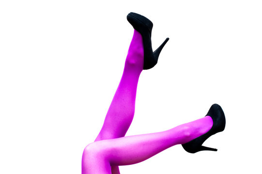 Female legs in pink pantyhose and black high heels
