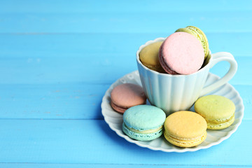 Assortment of gentle colorful macaroons in colorful mug