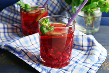 Pomegranate drink in glasses with mint and slices of lime