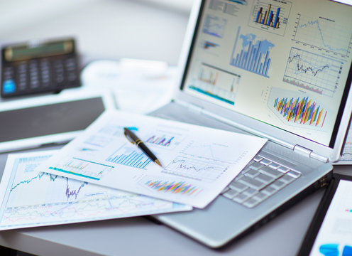 Analyzing Investment Charts With Laptop. Accounting