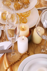 Beautiful holiday table setting in white and gold color