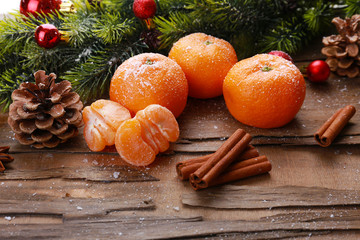 Christmas composition with tangerines on wooden background