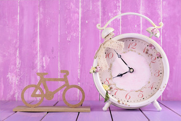 Beautiful vintage alarm clock with decorative bicycle