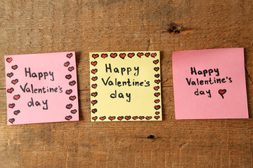 Valentines day notes on wooden background