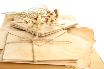 Old letters with dry flowers and book close up