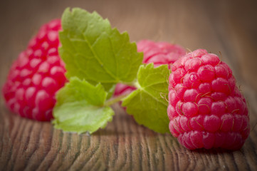 Fresh Raspberry close up on the wood table