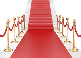 Staircase and red carpet between two gold stanchions with rope