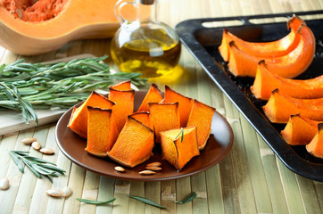 baked pumpkin, rosemary and olive oil on a kitchen table horizon