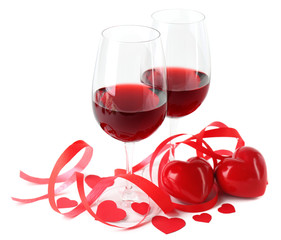 Composition with red wine in glasses, red roses, ribbon and