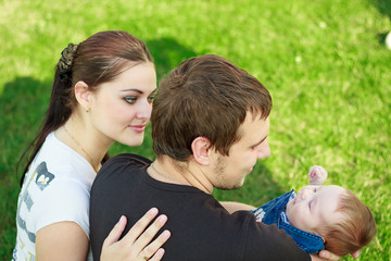 happy young family with baby in the park