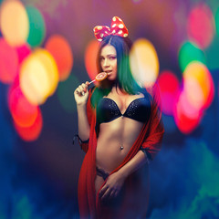 attractive girl in colorful light party with lolly