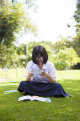 Girl sitting homework and reading.