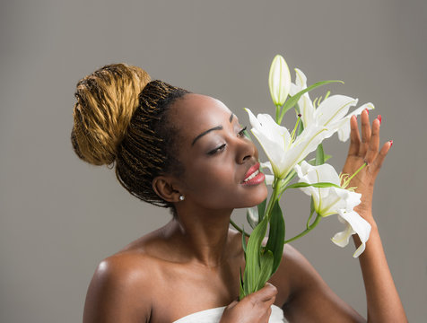 Sensual African woman lily flower in hair