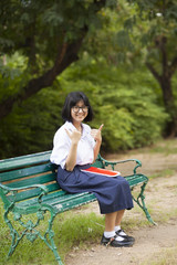 Schoolgirl. Sitting on the bench