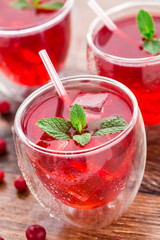 Cranberry cocktail with mint garnish.