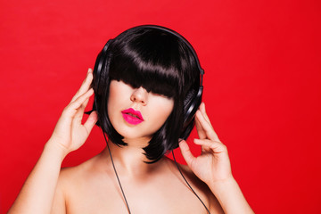 Woman dj listening to music on headphones enjoying a dance