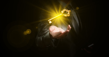 businessman hold a gold shining key, business concept