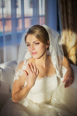 Obraz na płótnie Canvas beautiful bride sitting in a room