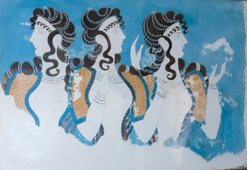 Aged fresco of three women profiles in Knossos