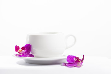 Fototapeta na wymiar Coffee cup and pink orchid flower