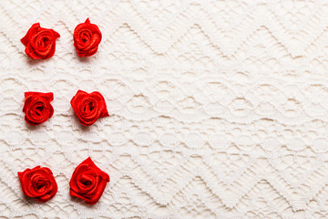 Frame of red silk roses on lace